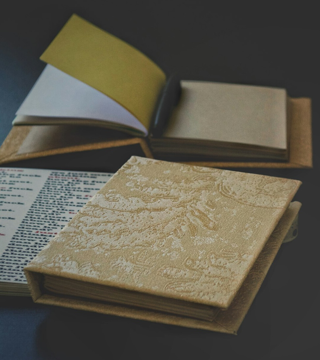 Stack of printed newspapers and a notebook